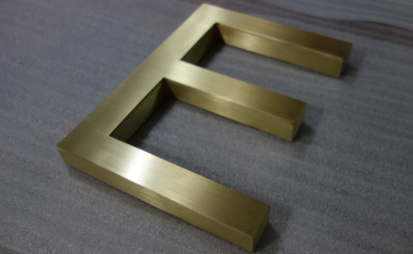 Brushed surface brass letters